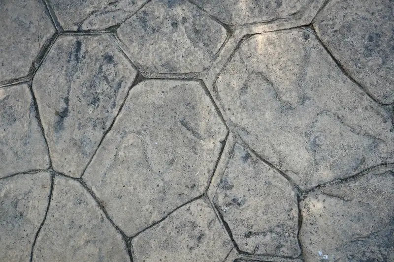 Close-up of gray concrete stamped in a random flagstone pattern