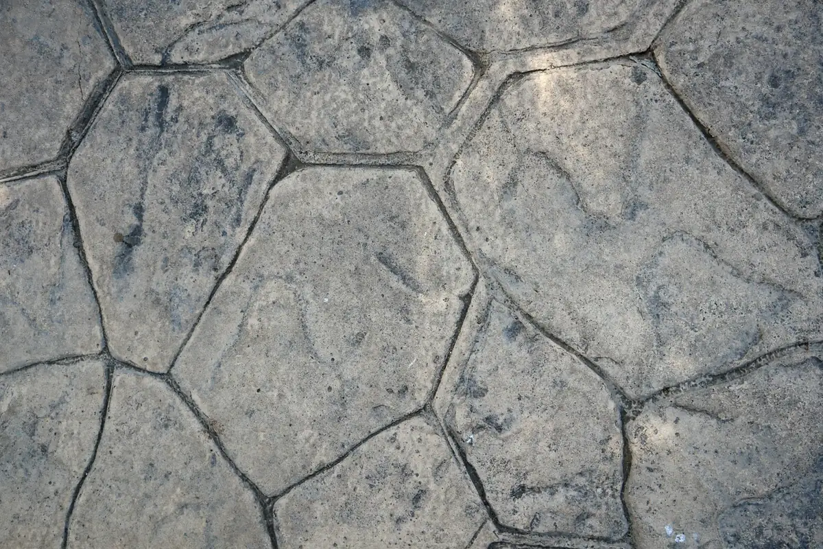 Close-up of gray concrete stamped in a random flagstone pattern